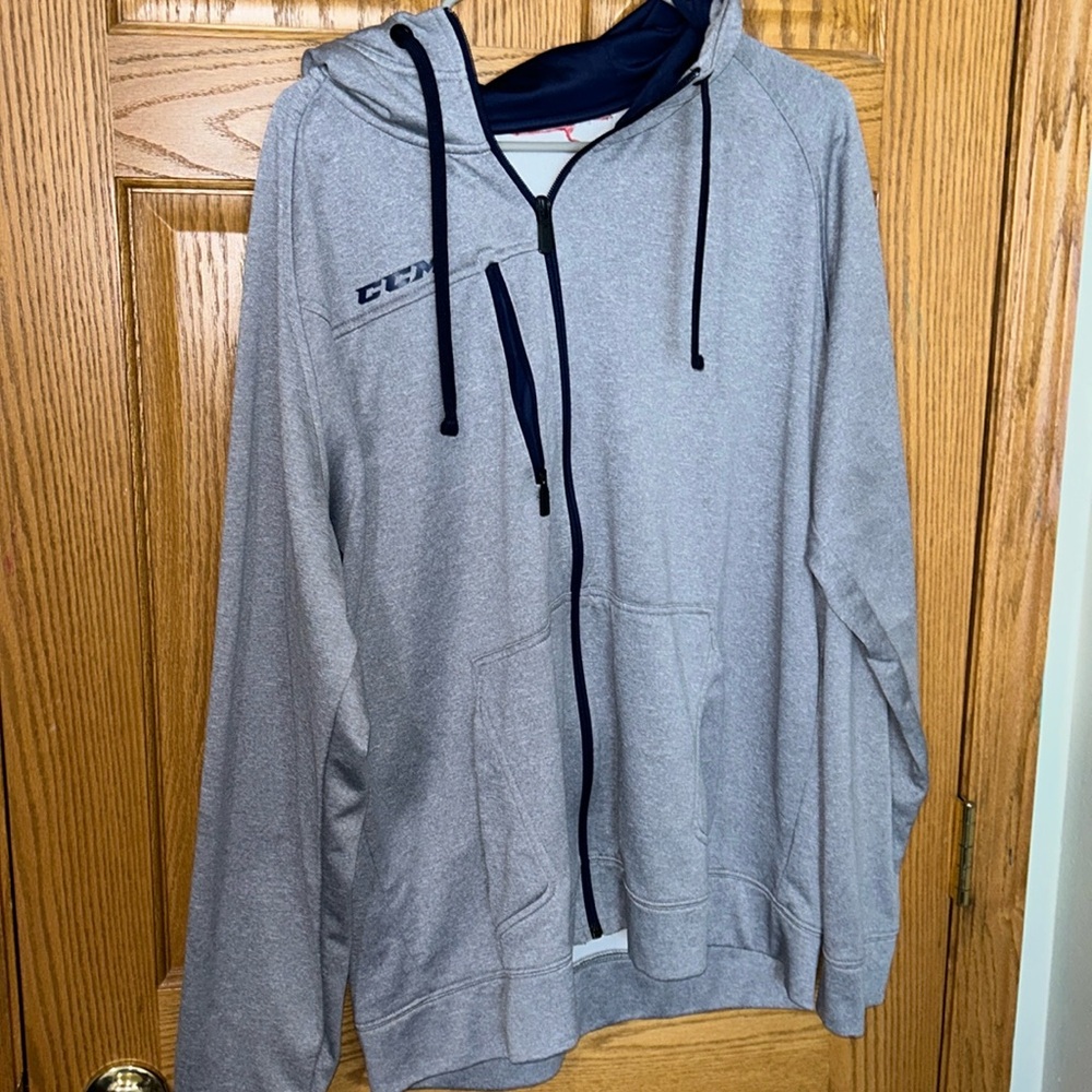 CCM xl zip up grey with navy blue detailing. Medium weight jacket.